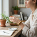 The Polka Dot Press thick disc stretch bracelet in worn gold finish worn by a woman holding a coffee cup.